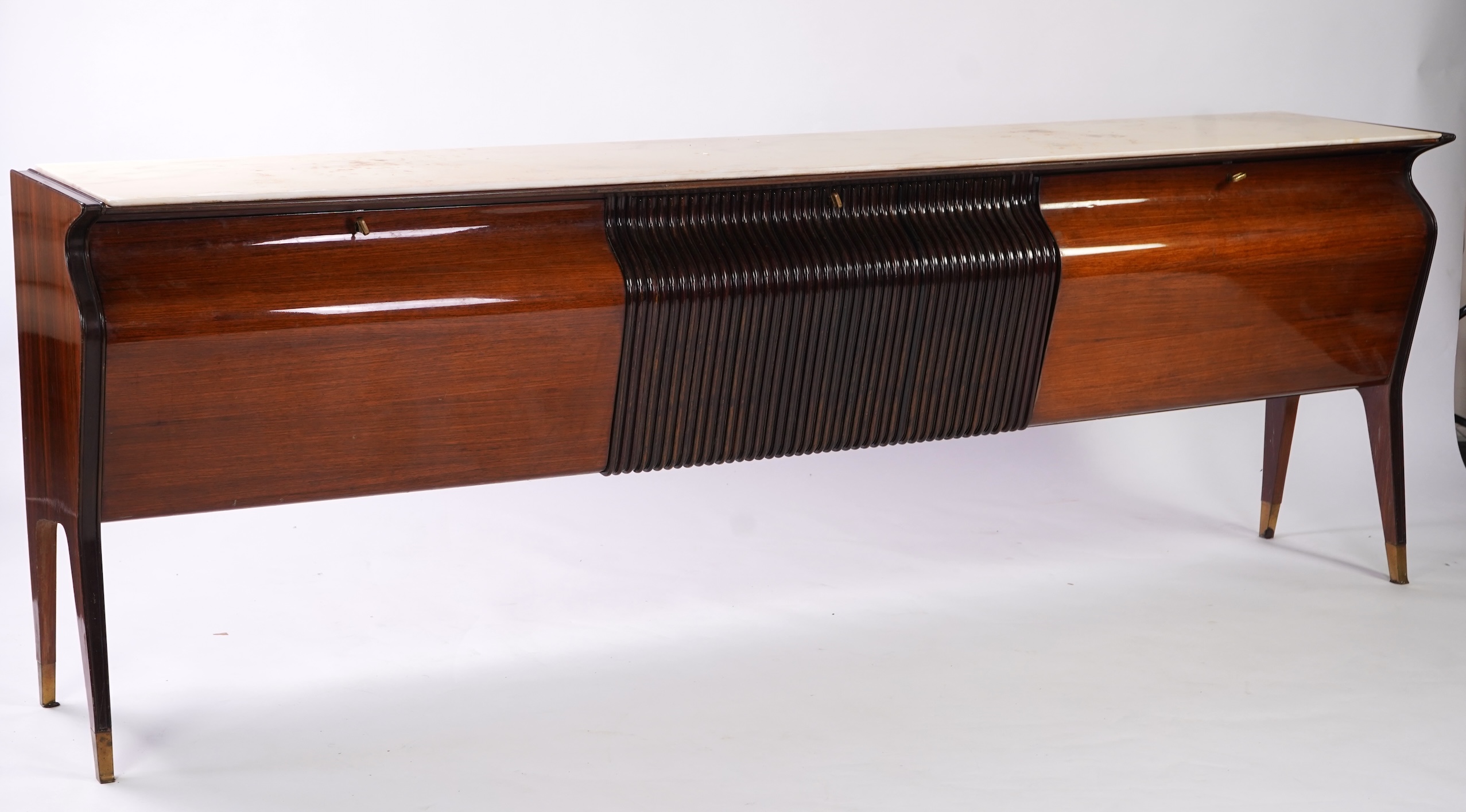 Osvaldo Borsani (Italian, 1911-1985) for Atelier Borsani Varedo: A large Indian rosewood and mahogany credenza, 276.5cm wide x 49cm deep x 94cm high